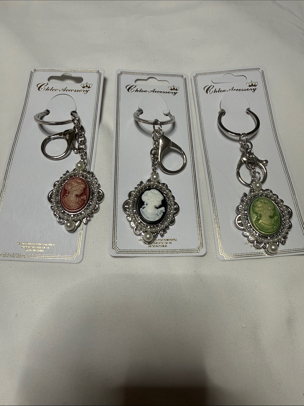Set of 3 Accessorize Vintage Cameo Keyring Trio in Red, Black, n Green , Silver